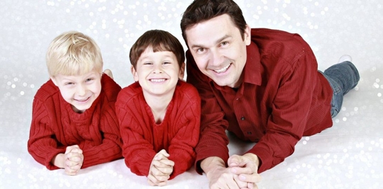 A father and his two kids having their picture taken.